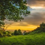 A picturesque sunset over the lush, green countryside of Deganwy, Wales, capturing nature's beauty.